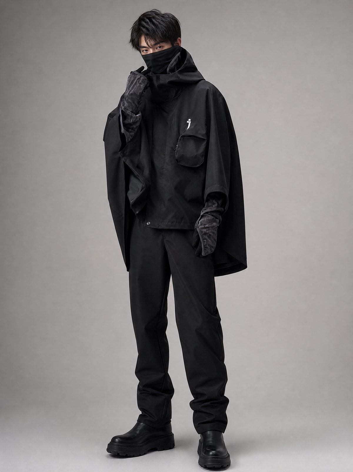 Worn by a Japanese male model: HiJ40 Black I-Tech Poncho